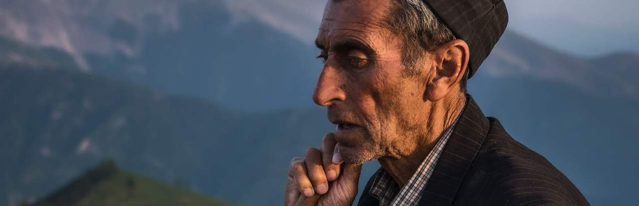 Photo of Central Asian man in the mountains by Peyman Toodari on Unsplash