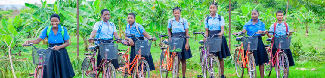 girls in school uniforms with bicycles