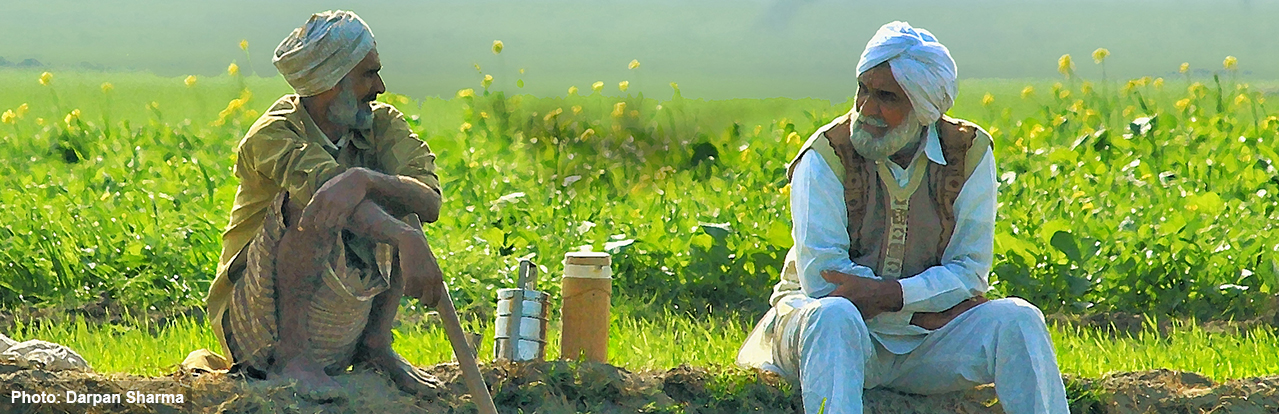 two men with turbans talking outdoors