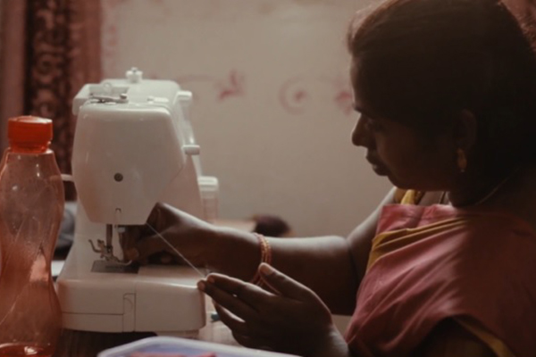 woman using sewing machine